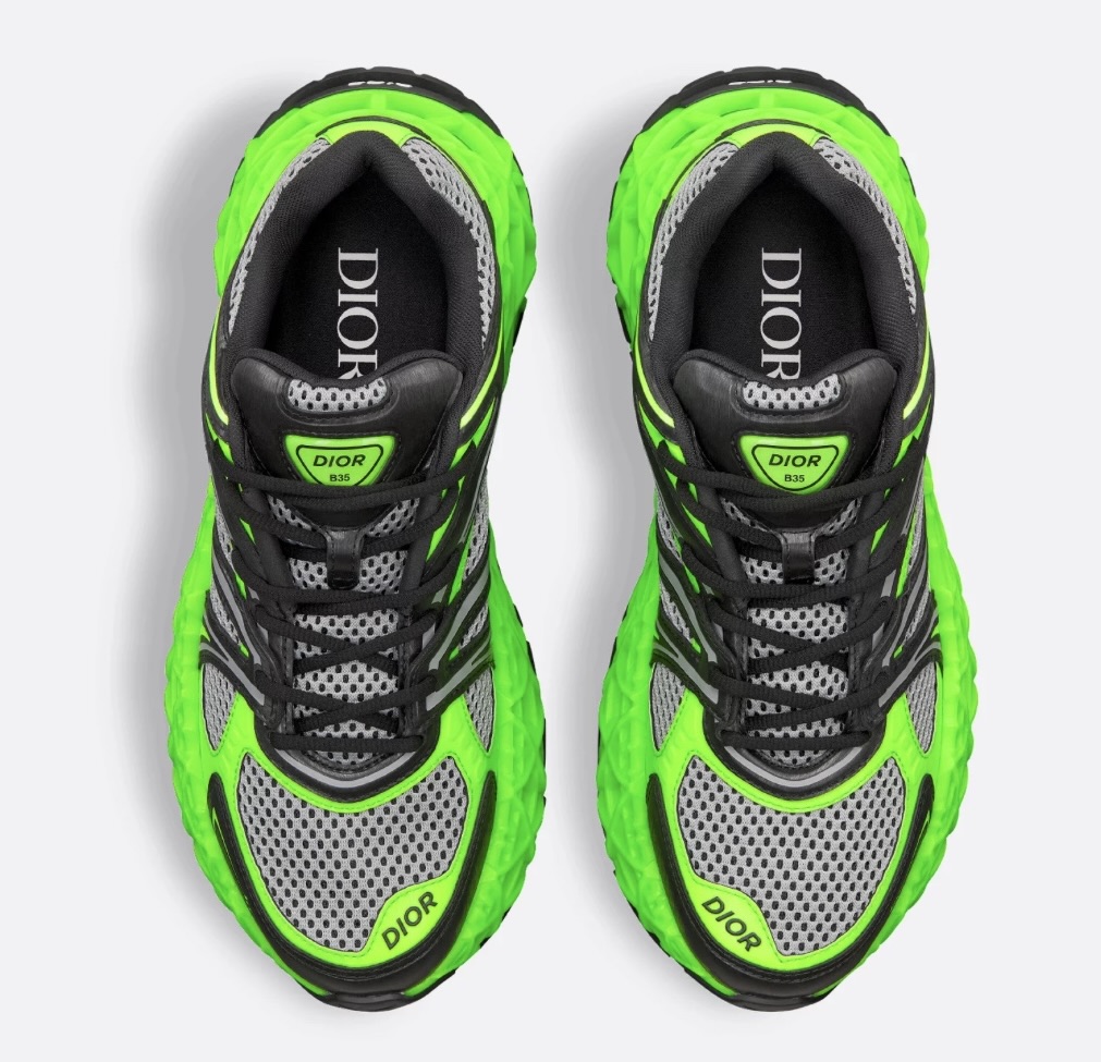 B35 NXXT limited edition shoe in neon green, black technical fabric, and gray mesh displayed on minimalist concrete backdrop